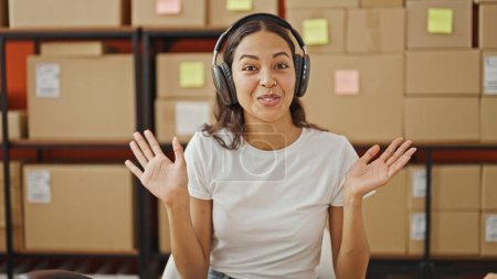Photo for African american woman ecommerce business worker using headphones having video call at office - Royalty Free Image