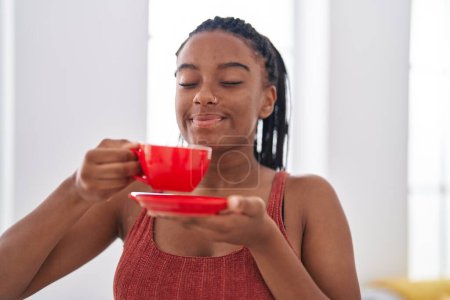 Photo for African american woman smiling confident drinking coffee at home - Royalty Free Image