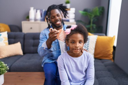 Photo for Father and daughter smiling confident combing hair at home - Royalty Free Image