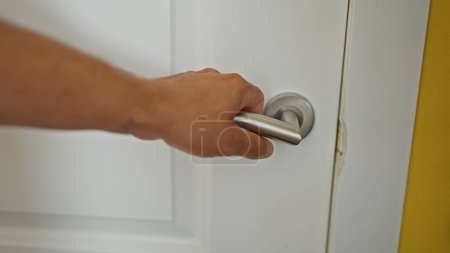 Photo for Young hispanic man opening door at home - Royalty Free Image