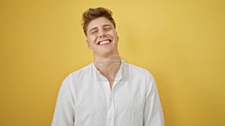 Photo for Laughing, confident young caucasian man in casual fashion, standing isolated against a yellow background, radiating positive vibes and joy - Royalty Free Image
