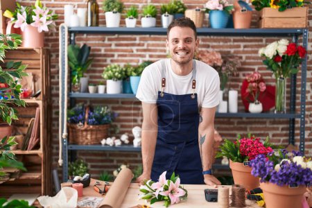 Photo for Young hispanic man florist smiling confident standing at florist - Royalty Free Image