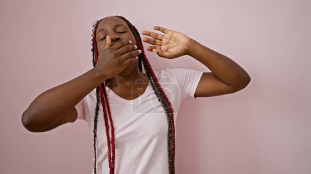 Photo for Exhausted african american woman savors relaxing stretch, yawning away tiredness over pink isolated background - Royalty Free Image