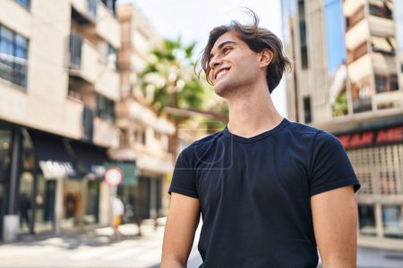 Photo for Young caucasian man smiling confident looking to the side at street - Royalty Free Image
