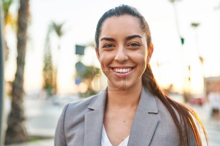 Photo for Young beautiful hispanic woman executive smiling confident standing at street - Royalty Free Image
