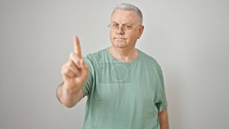 Photo for Middle age grey-haired man standing with serious expression saying no with finger over isolated white background - Royalty Free Image