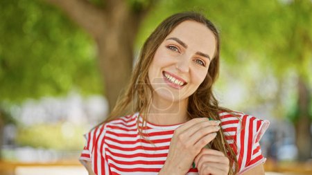 Photo for Young blonde woman smiling confident standing at park - Royalty Free Image