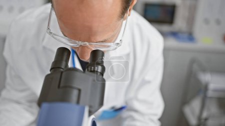Photo for Middle age man scientist using microscope at laboratory - Royalty Free Image
