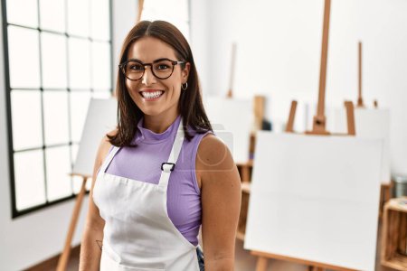 Photo for Young beautiful hispanic woman artist smiling confident standing at art studio - Royalty Free Image