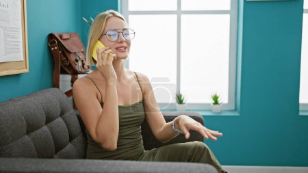 Photo for Young blonde woman business worker talking on smartphone smiling at the office - Royalty Free Image