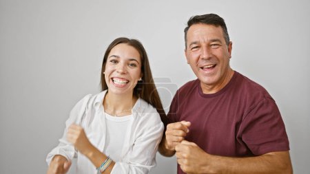 Téléchargez les photos : Père et fille confiants partageant une danse joyeuse, souriant sur fond blanc isolé, affichant un mode de vie familial hispanique heureux - en image libre de droit