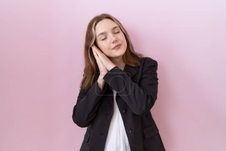 Photo for Young caucasian business woman wearing black jacket sleeping tired dreaming and posing with hands together while smiling with closed eyes. - Royalty Free Image