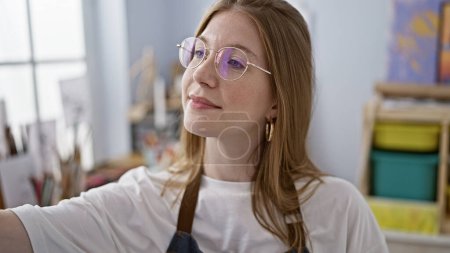 Photo for Young blonde woman artist smiling confident drawing at art studio - Royalty Free Image