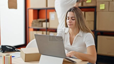 Photo for Two workers man and woman working using laptop at office - Royalty Free Image