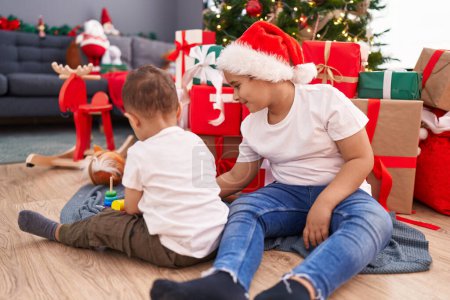 Photo for Adorable boys celebrating christmas playing with toy at home - Royalty Free Image