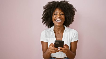 Photo for African american woman using smartphone smiling over isolated pink background - Royalty Free Image