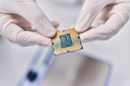 Photo for Young hispanic man scientist holding cpu processor chip at laboratory - Royalty Free Image