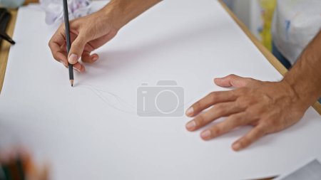 Photo for Hispanic man's hands drawing with fervor in art studio, sketching life on paper with pencil - Royalty Free Image
