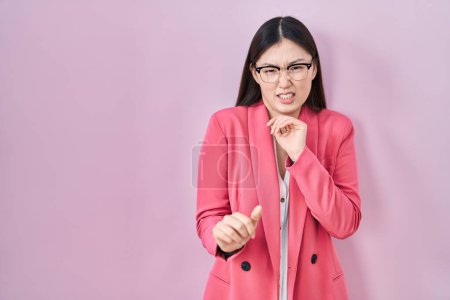 Photo for Chinese business young woman wearing glasses disgusted expression, displeased and fearful doing disgust face because aversion reaction. with hands raised - Royalty Free Image