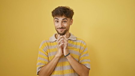 Photo for Young arab man smiling confident standing with hands together over isolated yellow background - Royalty Free Image