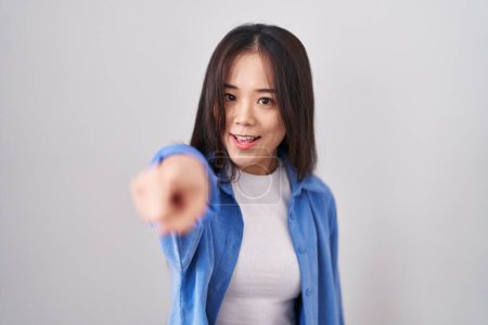 Photo for Young chinese woman standing over white background pointing displeased and frustrated to the camera, angry and furious with you - Royalty Free Image
