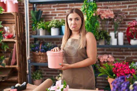 Photo for Young blonde woman working at florist shop depressed and worry for distress, crying angry and afraid. sad expression. - Royalty Free Image