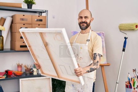 Photo for Young bald man artist smiling confident looking draw at art studio - Royalty Free Image