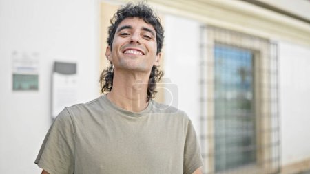 Photo for Young hispanic man smiling confident standing at street - Royalty Free Image