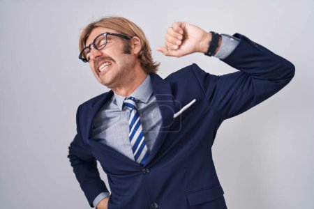 Photo for Caucasian man with mustache wearing business clothes stretching back, tired and relaxed, sleepy and yawning for early morning - Royalty Free Image