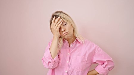Photo for Young blonde woman stressed standing over isolated pink background - Royalty Free Image