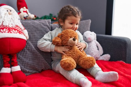 Photo for Adorable hispanic toddler smiling confident sitting on sofa with christmas decoration at home - Royalty Free Image