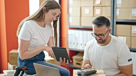 Photo for Young woman and man working on ecommerce with tablet at office - Royalty Free Image