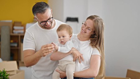 Photo for Family of mother, father and baby smiling together at new home - Royalty Free Image