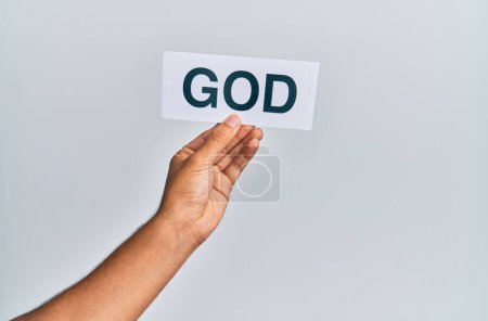 Téléchargez les photos : Hand of caucasian man holding paper with god word over isolated white background - en image libre de droit