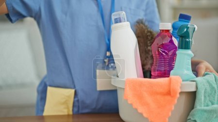 Photo for Young blonde woman professional cleaner holding products at coffee shop terrace - Royalty Free Image