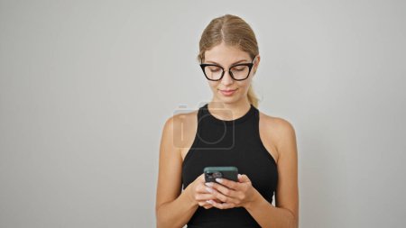 Photo for Young blonde woman using smartphone over isolated white background - Royalty Free Image