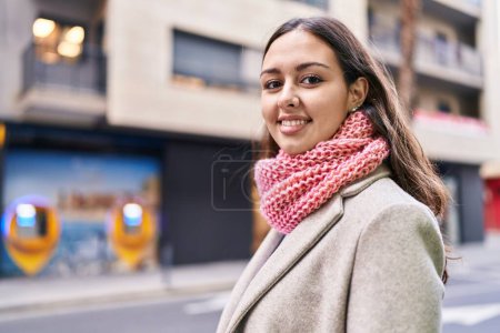 Foto de Young beautiful hispanic woman smiling confident wearing scarf at street - Imagen libre de derechos