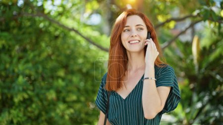 Téléchargez les photos : Young redhead woman smiling confident talking on the smartphone at park - en image libre de droit