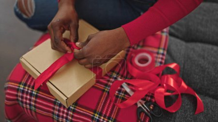 Photo for African american woman preparing christmas gift at home - Royalty Free Image