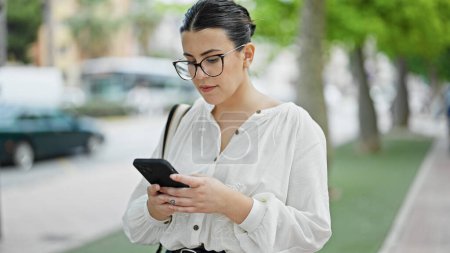 Photo for Young beautiful hispanic woman using smartphone at street - Royalty Free Image
