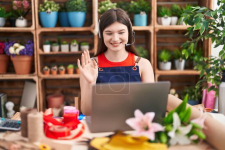 Photo for Young caucasian woman working at florist shop doing video call looking positive and happy standing and smiling with a confident smile showing teeth - Royalty Free Image