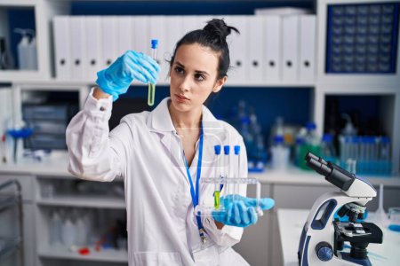 Photo for Young caucasian woman scientist holding test tubes at laboratory - Royalty Free Image