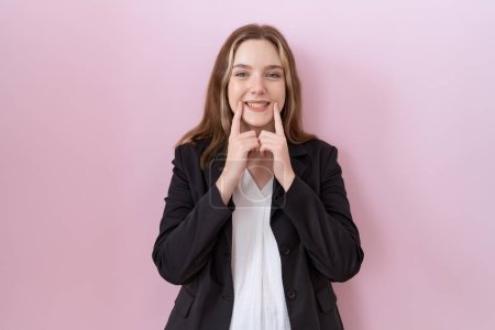 Téléchargez les photos : Jeune femme d'affaires caucasienne portant une veste noire souriant avec la bouche ouverte, les doigts pointant et forçant sourire joyeux - en image libre de droit