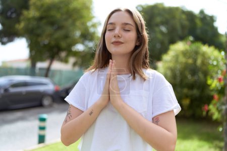 Photo for Young caucasian woman doing yoga exercise at park - Royalty Free Image