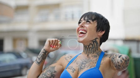 Photo for Hispanic woman with amputee arm smiling confident looking to the sky celebrating at street - Royalty Free Image