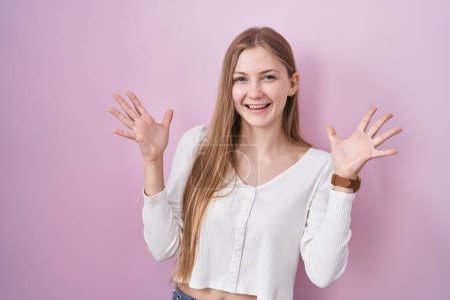 Photo for Young caucasian woman standing over pink background celebrating crazy and amazed for success with arms raised and open eyes screaming excited. winner concept - Royalty Free Image