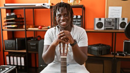 Photo for African american man musician smiling confident holding guitar at music studio - Royalty Free Image
