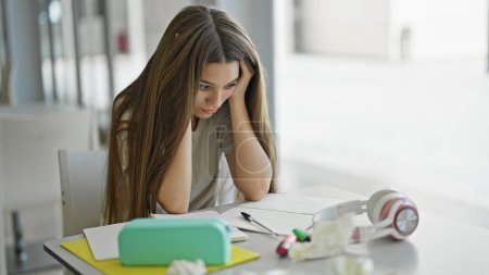 Photo for Young beautiful girl studying stressed at library - Royalty Free Image