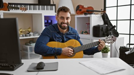 Photo for Soulful strumming by smiling young hispanic man, classic melody immersed in music studio performance on acoustic guitar - Royalty Free Image