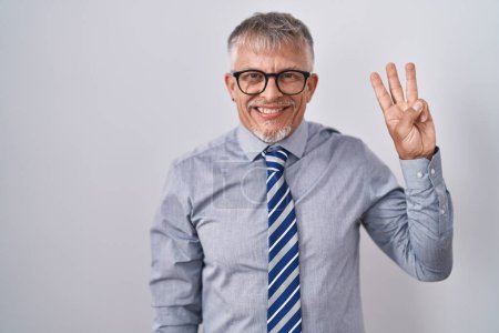 Photo for Hispanic business man with grey hair wearing glasses showing and pointing up with fingers number three while smiling confident and happy. - Royalty Free Image